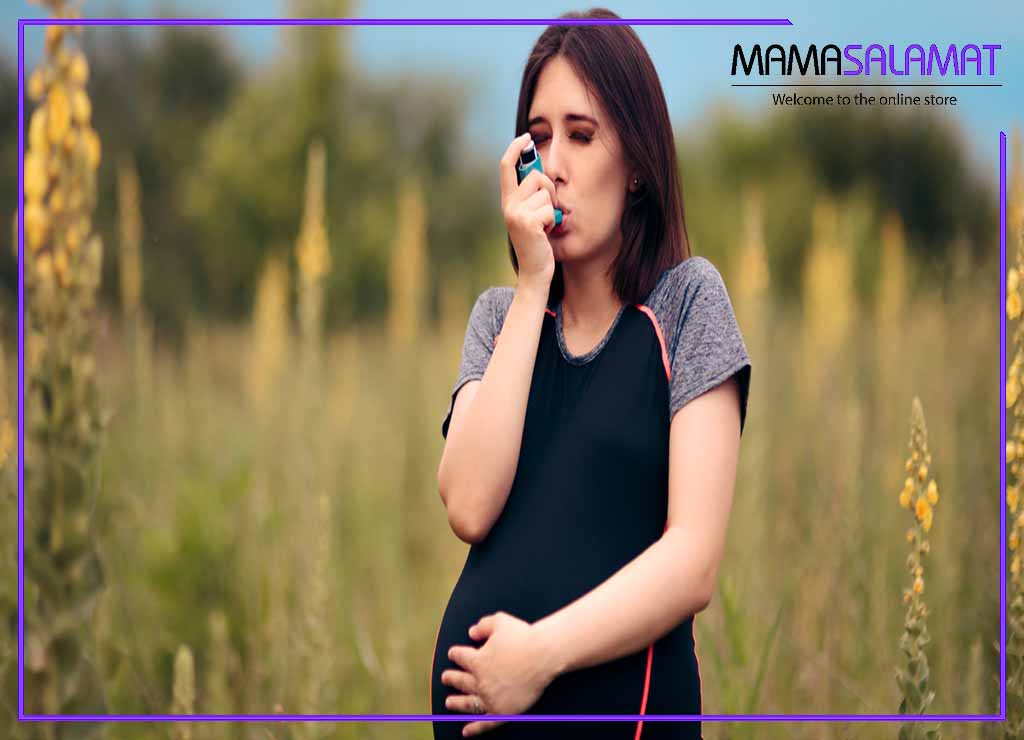 آسم در بارداری تصویر خانم باردار در طبیعت در حال استفاده از اسپری تنفسی